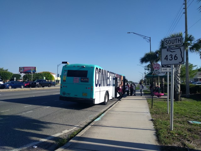 People boarding and alighting a bus